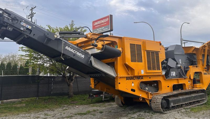 An Anaconda J12 jaw crusher parked in the Skreenquip yard in Delta, under the Skreenquip sign