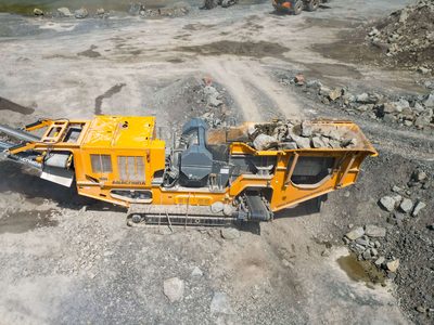 Anaconda J12 jaw crusher in a quarry from above, its hopper full of rock