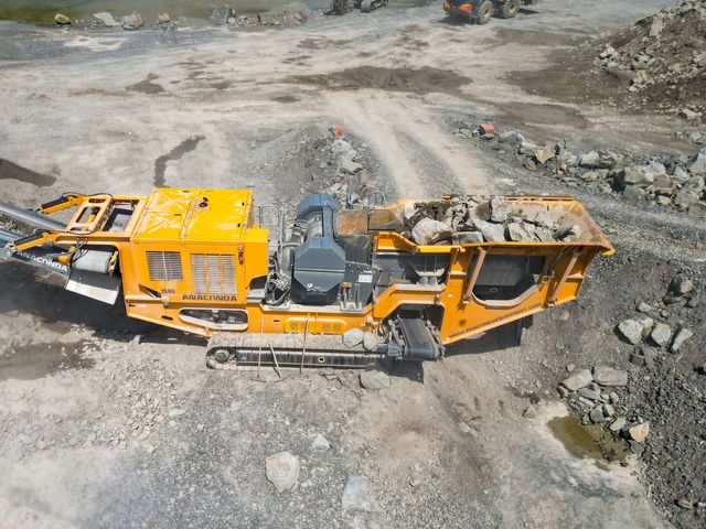 Anaconda J12 jaw crusher in a quarry from above, its hopper full of rock