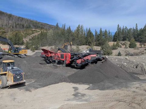The 2019 Finlay I-120RS impact crusher on a gravel job site, with an excavator and a loader working nearby
