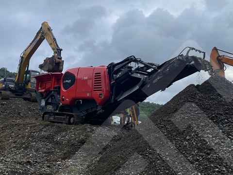 Manufacturer photo, not this unit: A J-960 jaw crusher being fed by an excavator